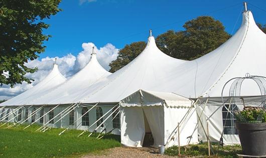 a row of portable restrooms at an outdoor festival, providing comfort and sanitation for attendees in Inverness